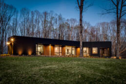 a modern house in the woods at dusk photographed by Asheville architectural photographer