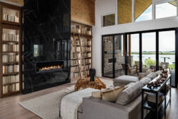 living room with large book shelf and fireplace highlighting captured by Charlotte interior design photographer