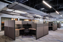 An open office with cubicles and desks ideal for commercial photography.