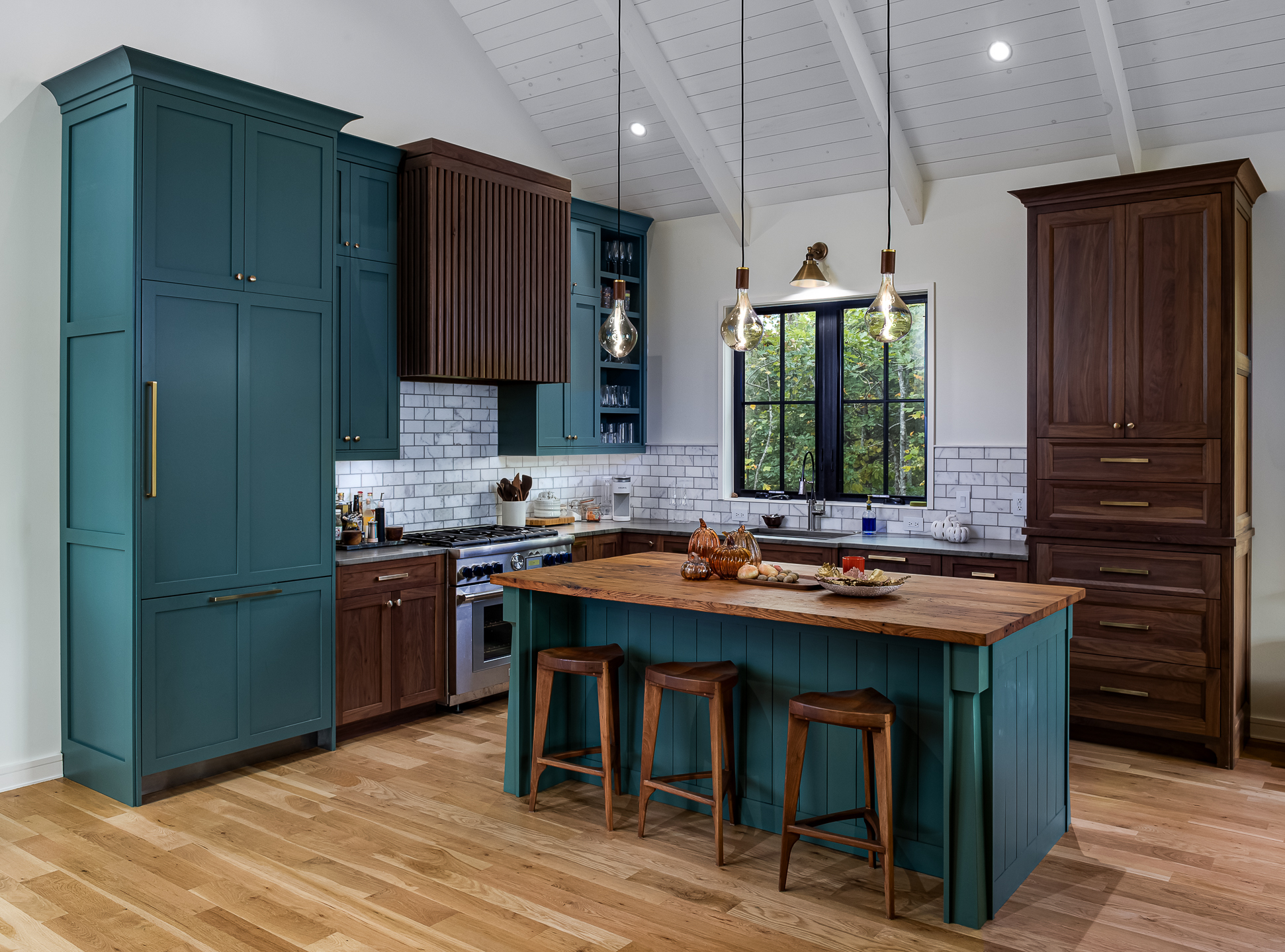 Interior design photography of a kitchen with teal cabinets and wooden floors taken by Atlanta interior photographer