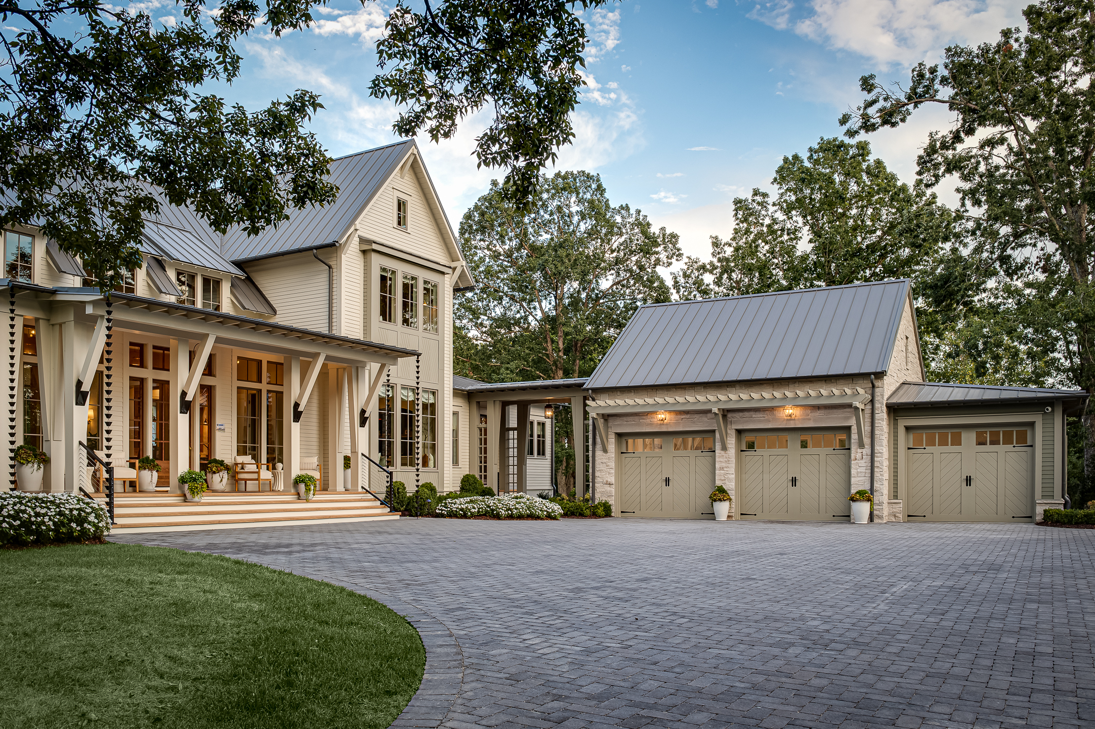 A home with two garages and a driveway taken by an architectural photographer in Nashville