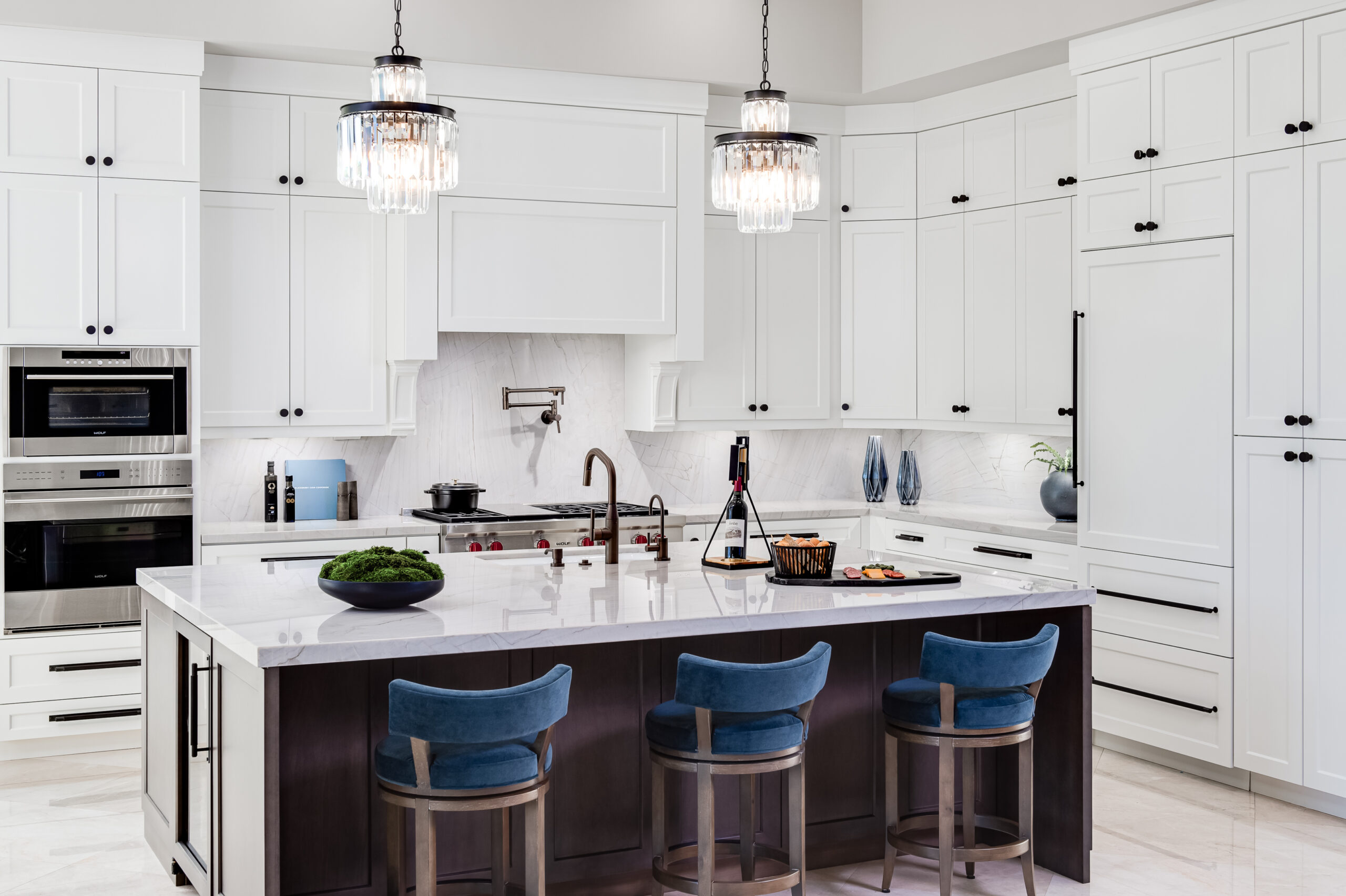A white kitchen with blue barstools photographed by professional interior design photographer