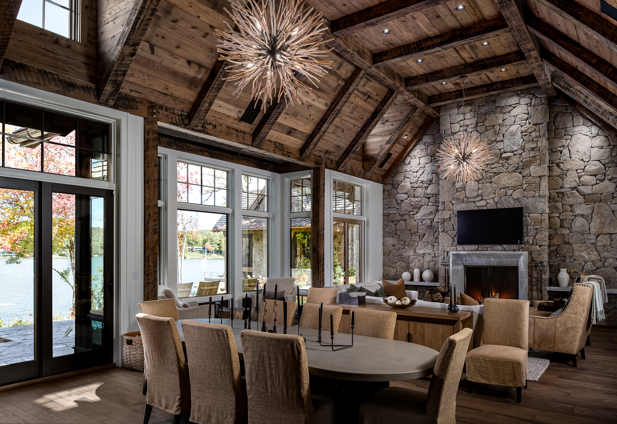 A large living room with stone walls and a fireplace. captured by a commercial architectural photographer