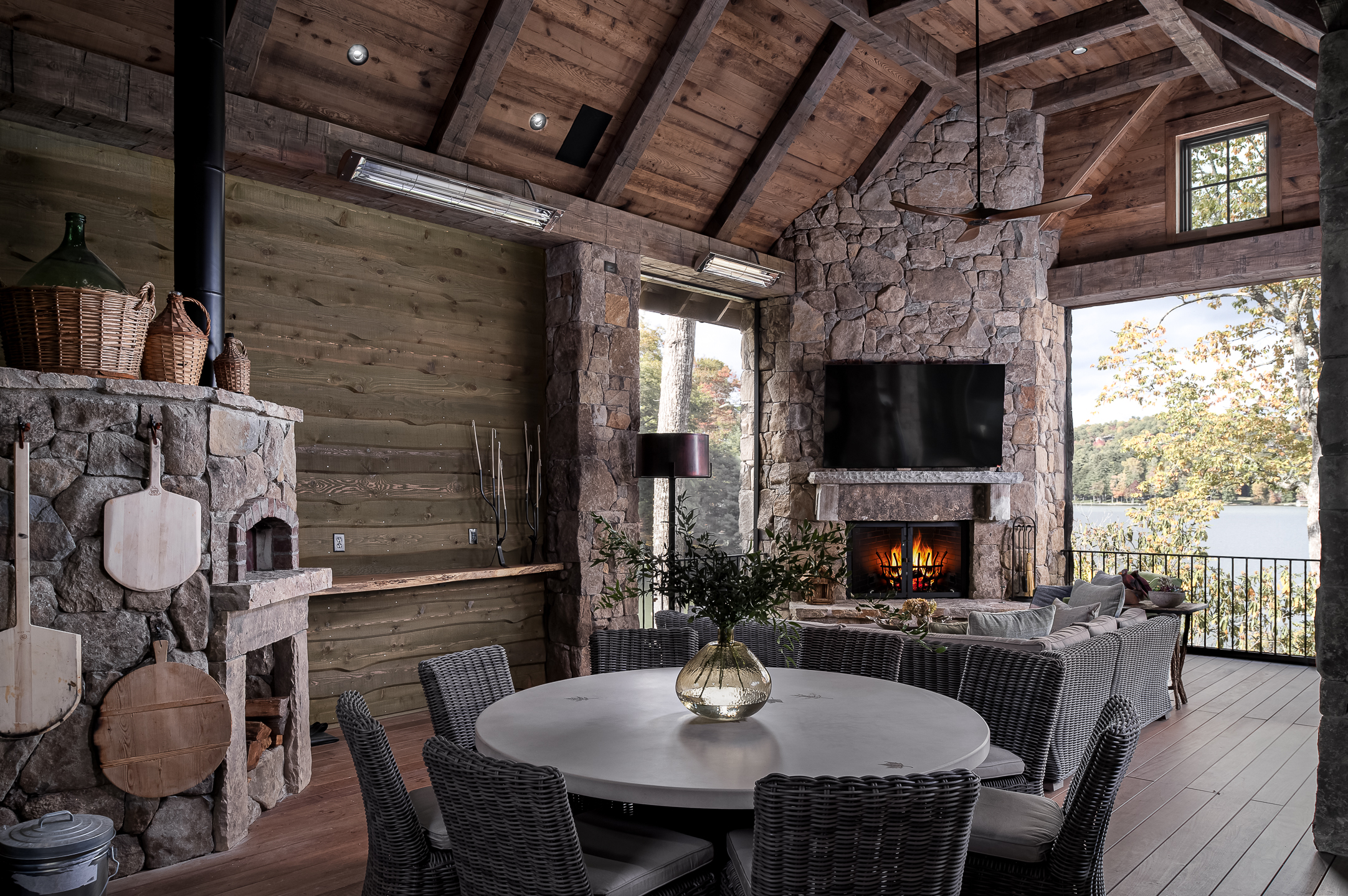 A living room with a fireplace and a dining table. captured by professional architectural photographer in North Carolina