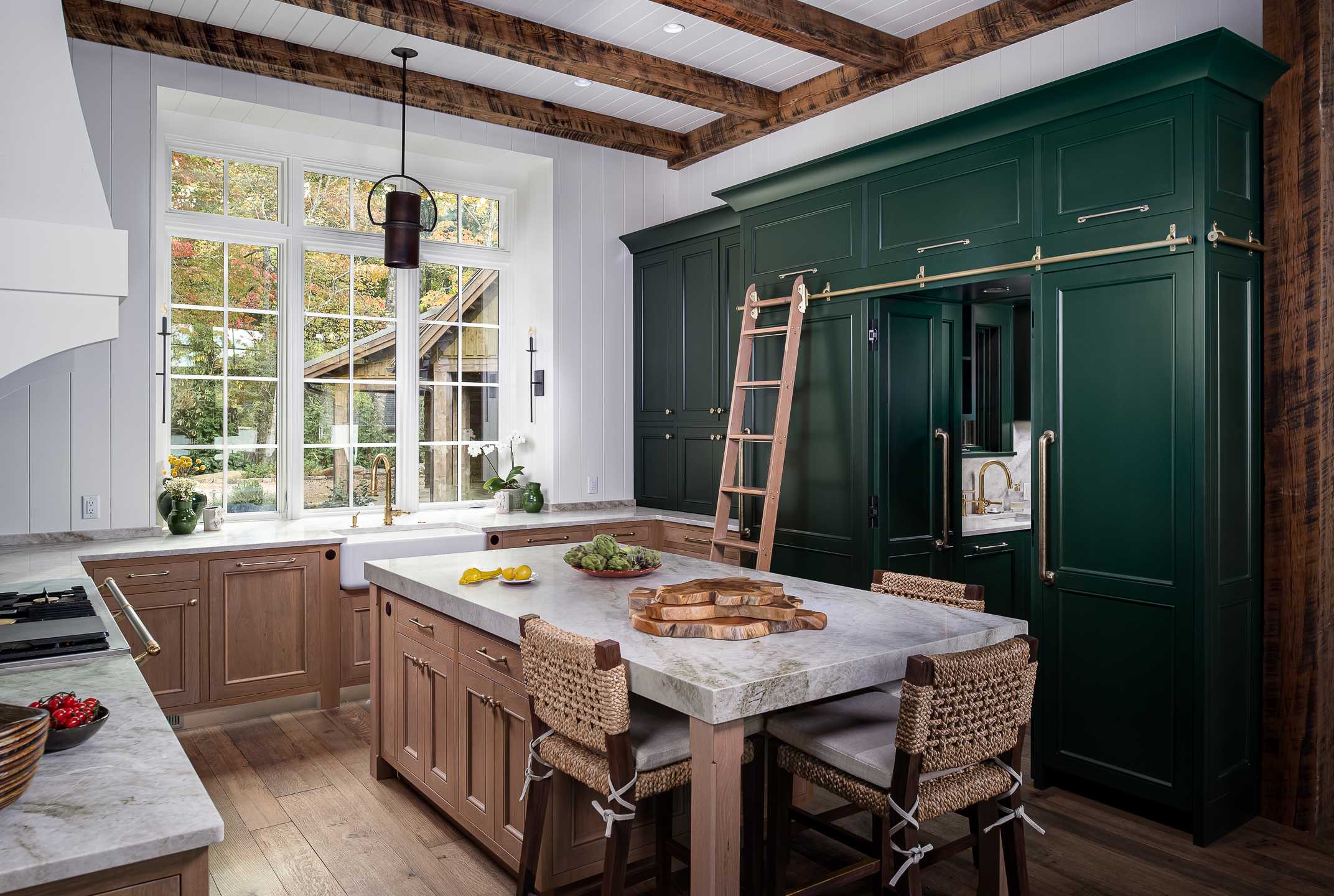 A kitchen with green cabinets and wooden beams. captured by a professional interiors photographer
