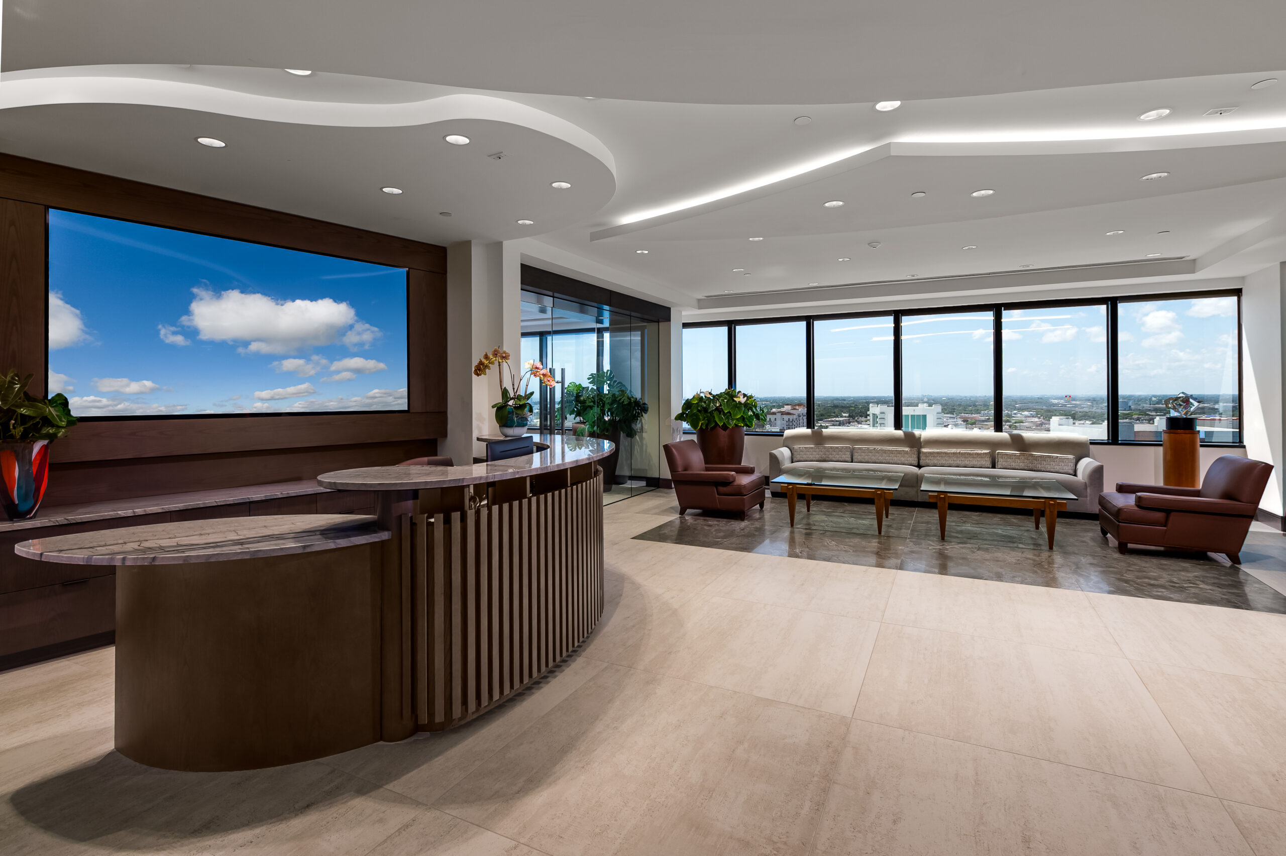 the lobby of a modern office building with a large tv.