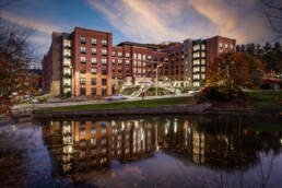 a large building with a pond in front of it in Boone, North Carolina photographed by professional building photographer