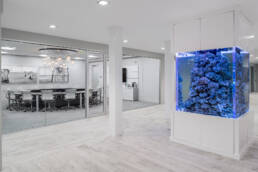 an office with a large aquarium in the middle of the room.