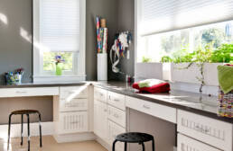 a white kitchen with white cabinets and white counter tops.