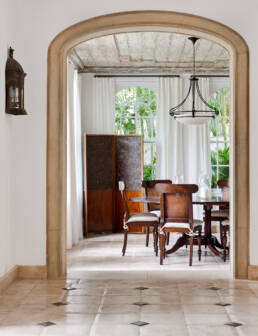 An archway showcasing an elegant dining room (Interior Design Detail).