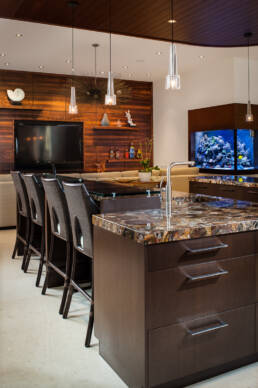 a kitchen with a large fish tank.