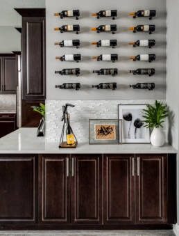 a kitchen with wine bottles on the wall.