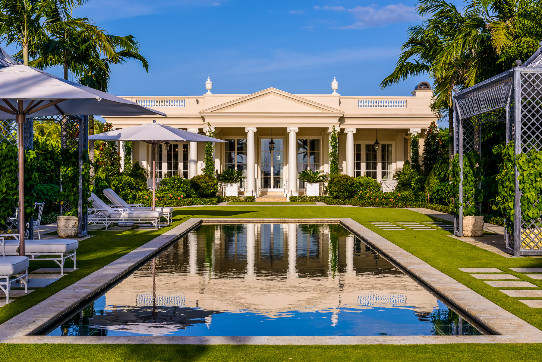 an elegant pool in front of a regency style house shot by professional home photographer from Asheville, North Carolina