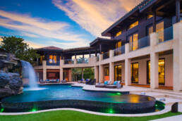 An expert home photographer captures a Florida mansion with a pool and waterfall.