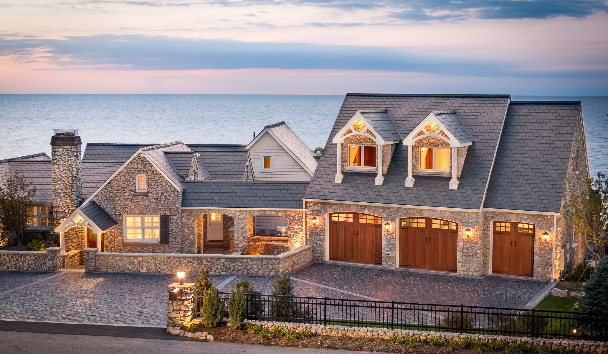 a home with a garage and a view of the ocean.
