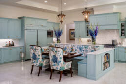 a kitchen with blue cabinets and a table and chairs.