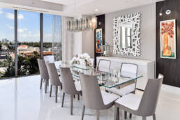 a modern dining room with a glass table and chairs.