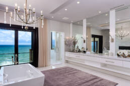 a bathroom with a large window overlooking the ocean.