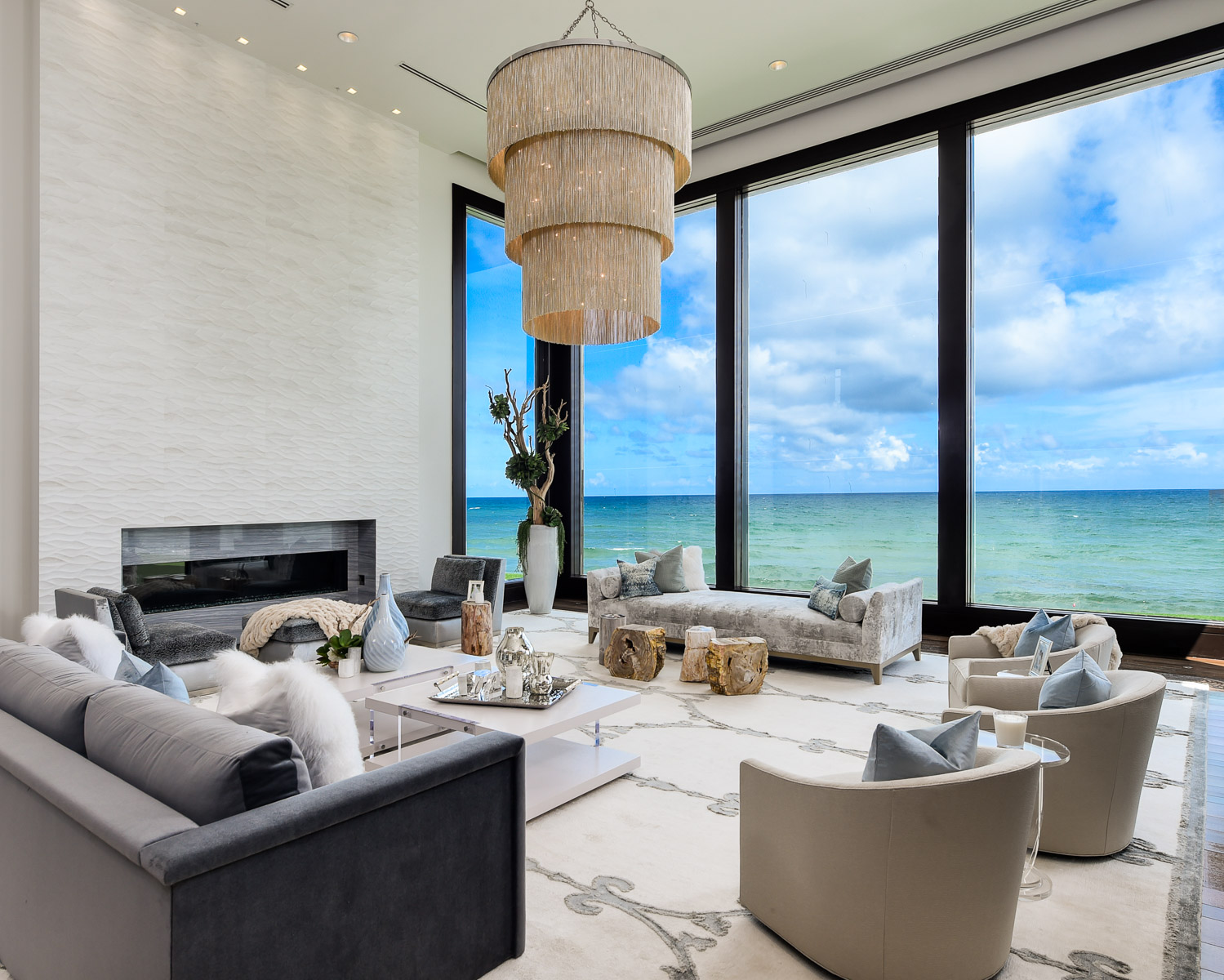 a living room with large windows overlooking the ocean.