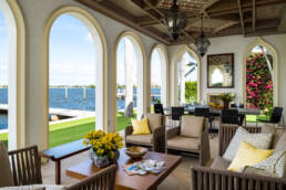 an arched patio with furniture and a view of the water photographed by professional architectural photographer