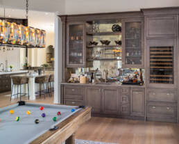 a pool table in a kitchen.