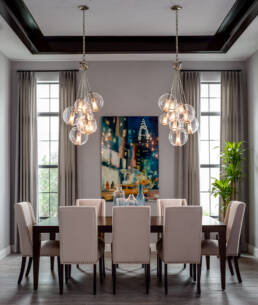 a dining room with a chandelier and chairs captured by Asheville architectural photographer