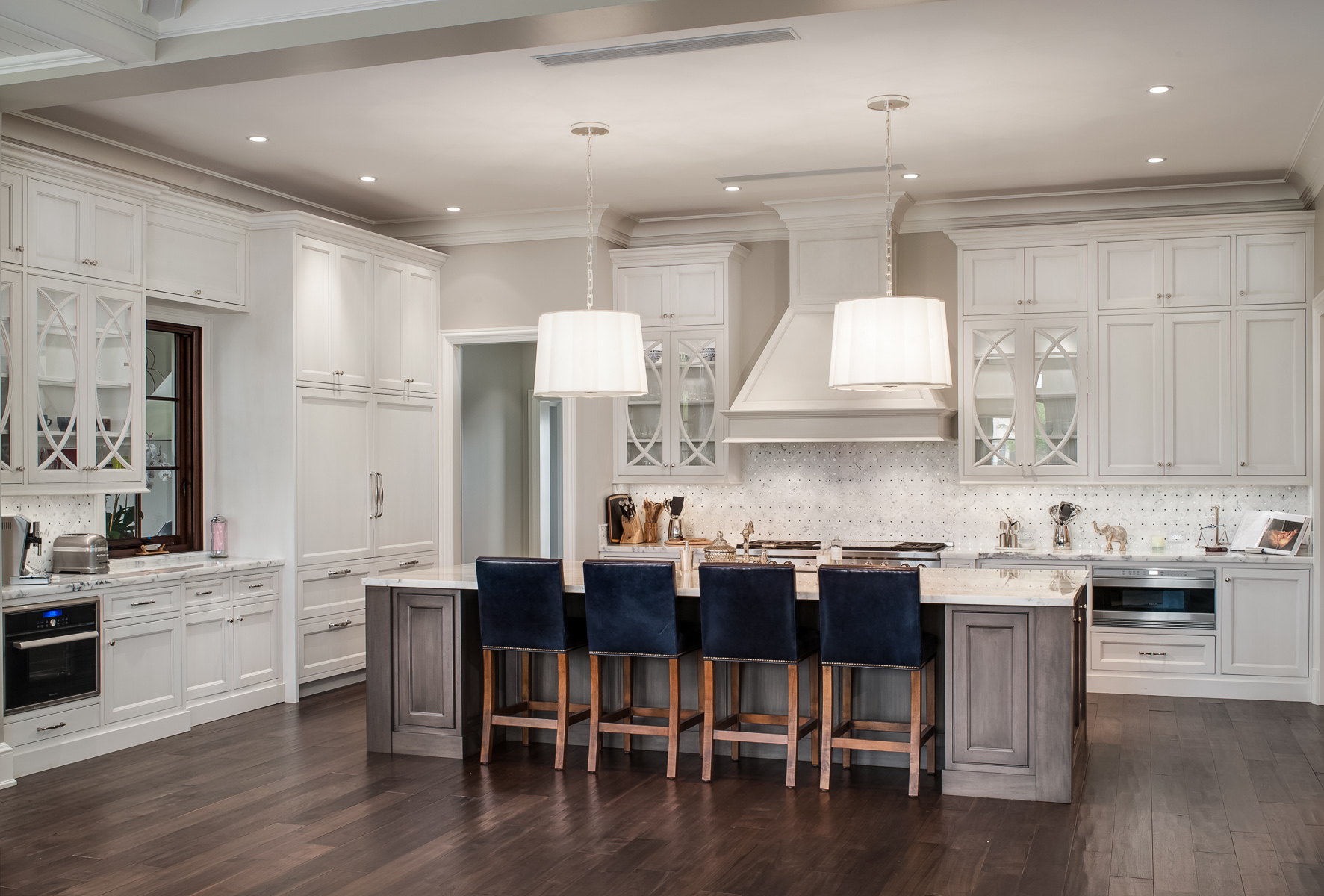 a large kitchen with white cabinets and a center island.