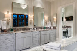 a bathroom with two sinks and a large mirror.