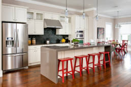 a kitchen with red stools.